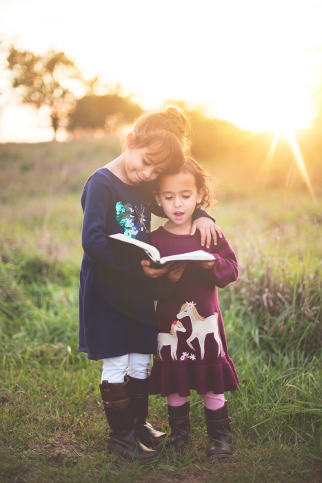 Children reading together outside